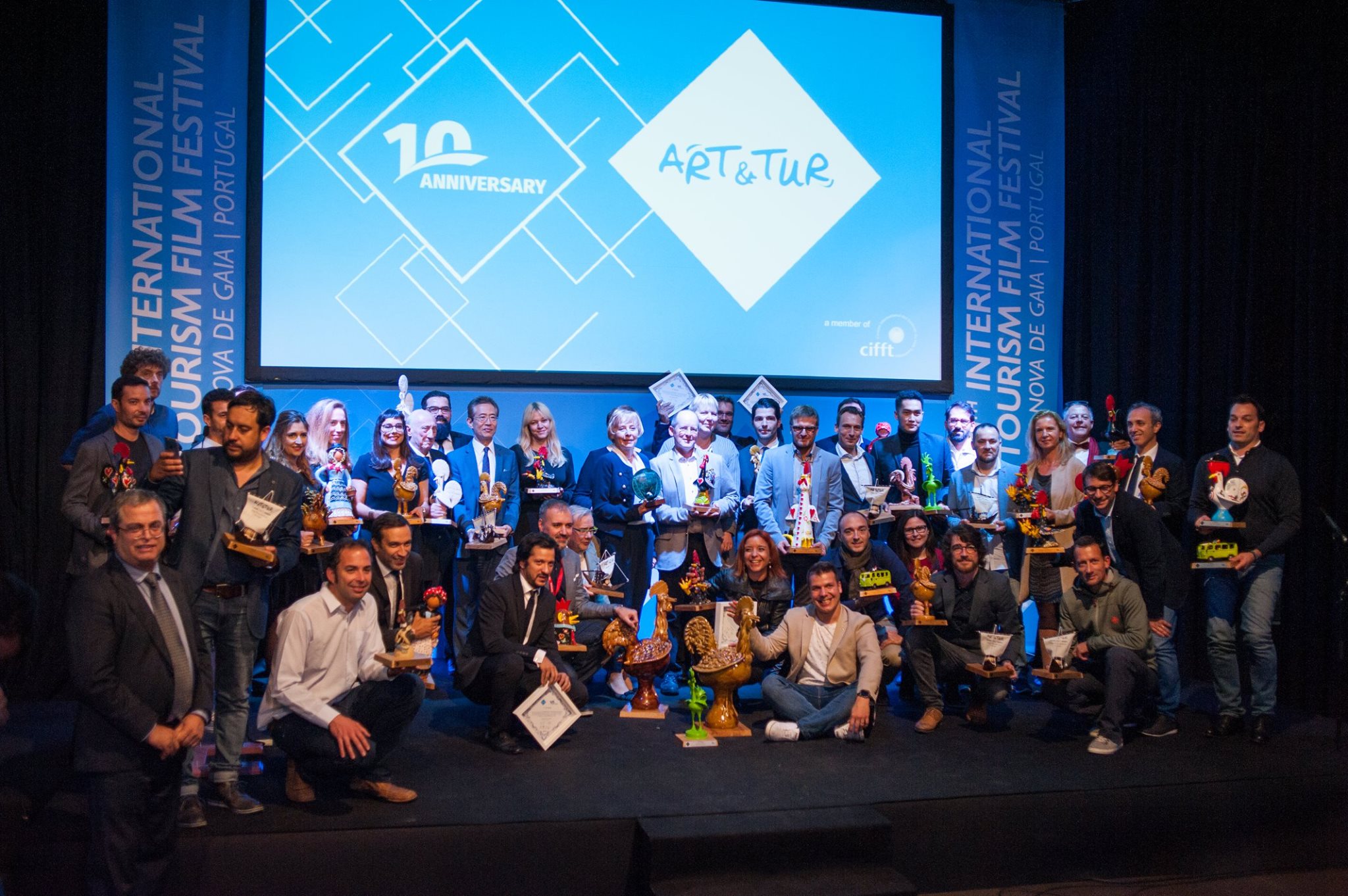 Award winners on stage at a tourism film festival