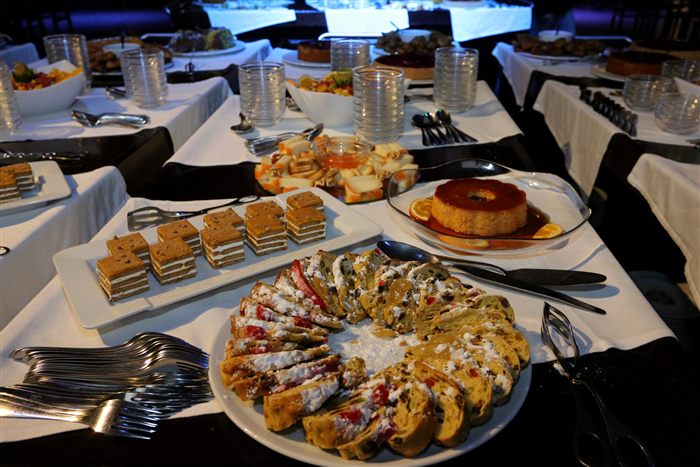 Dessert table with cakes and pudding