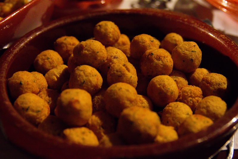Fried savoury snacks in a clay dish