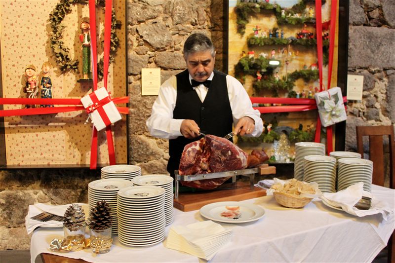 Waiter carving ham at a buffet